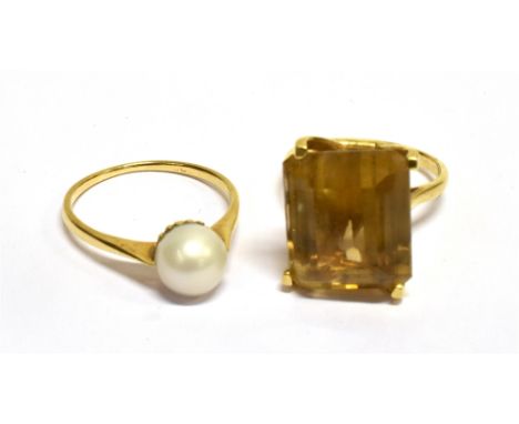 A MODERN RECTANGULAR CITRINE SINGLE STONE RING AND A CULTURED-PEARL SINGLE STONE RING the step-cut stone measures approx. 14m