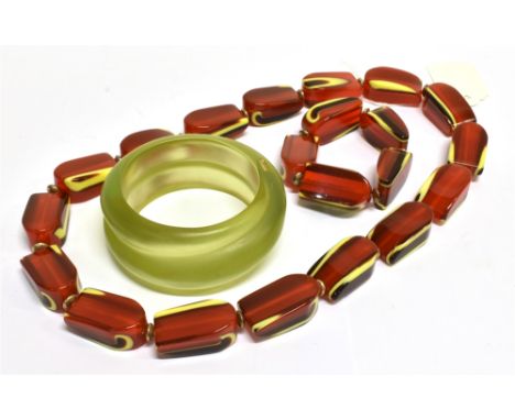 A RED, YELLOW AND BLACK LAYERED-PLASTIC ABSTRACT-OBLONG BEAD NECKLACE AND A MATCHING BRACELET the necklace approx. 64cm long 