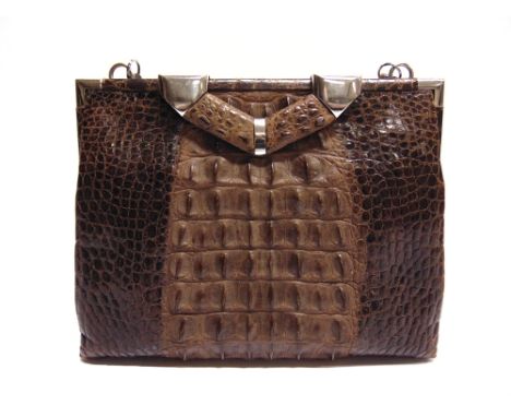 A CROCODILE SKIN HANDBAG  the unlabelled interior with two pockets containing a small mirror (cracked) and a purse, the bag 2