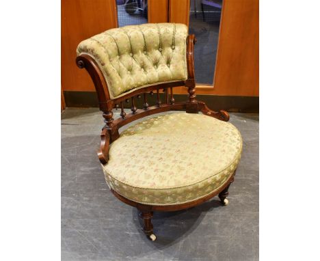 A LATE VICTORIAN WALNUT FRAMED SALON CHAIR  with button upholstered back and oval seat, on turned and fluted front supports