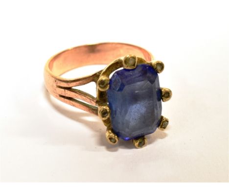 A SAPPHIRE AND DIAMOND CLUSTER RING the rectangular step-cut stone, approximately 2.75cts within a tiny diamond eight-claw se