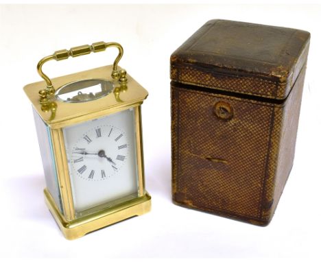 A BRASS CASED CARRIAGE CLOCK  the enamel dial with Roman numerals, in carrying case