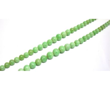 A JADEITE BEAD TWO ROW NECKLACE the rows of 55 &amp; 59 slightly mottled light-green round beads graduated approx. 9.8mm to 4