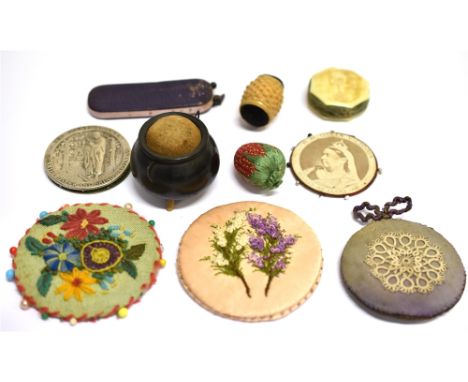 SEWING - A COLLECTION OF PIN WHEELS &amp; NOVELTY PIN CUSHIONS  comprising a pressed metal pin wheel embossed with an image o