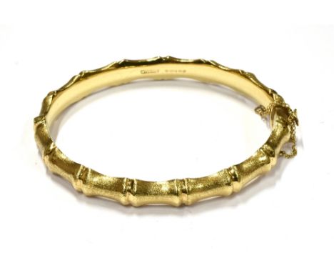 A VINTAGE 9CT GOLD 'BAMBOO' HINGED BANGLE Naturalistically shaped and lightly-textured, Birmingham 1967, 11.5g 