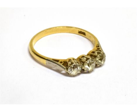 A MID 20TH CENTURY GOLD AND DIAMOND THREE STONE RING the old-cut stones approx. 0.98cts total, claw set in white to a yellow 