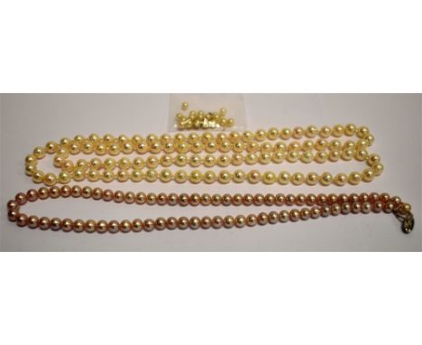 TWO CULTURED PEARL SINGLE ROW NECKLACES comprising; a row of 73 cream dark-rose beads approx. 6.0-6.4mm diameter, knotted on 