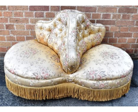 AN UNUSUAL VICTORIAN BUTTON UPHOLSTERED DOUBLE-ENDED SOFA  on turned supports with ceramic casters, 120cm wide