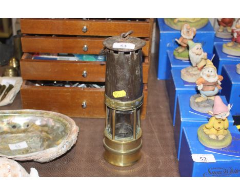 A vintage brass and metal miners lamp