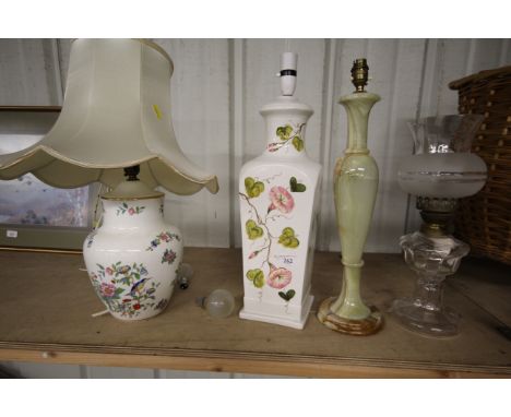 A glass oil lamp, an Aynsley porcelain table lamp and two other table lamps 