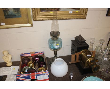 A Victorian brass based oil lamp with blue glass reservoir and opaque shade