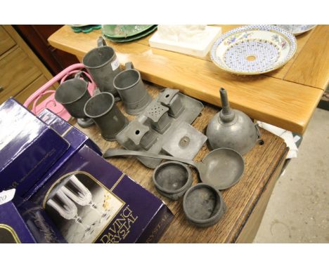 A collection of antique pewter to include a desk stand, funnel, ladle, various tankards etc. 