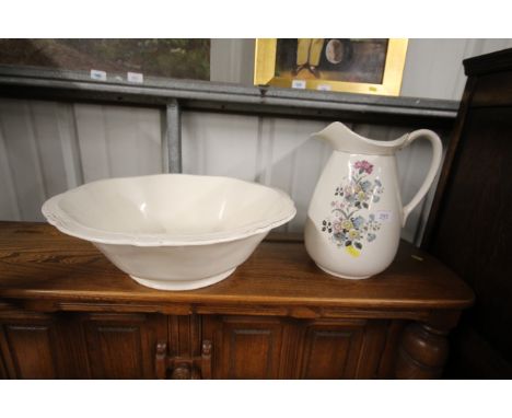 A floral decorated toilet jug; and a large wash basin with gilt decoration