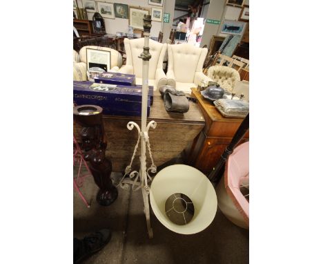 An antique wrought metal standard lamp converted to electricity