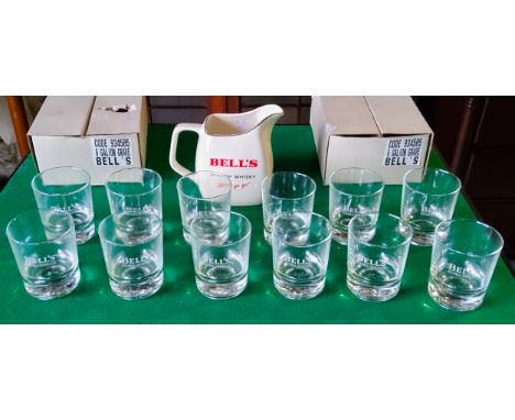 A Bell's whisky water jug by Wade and twelve weighted Bell's whisky '8 year' tumblers (13) Excellent Condition.