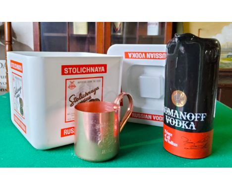 A Stolichnaya Russian Vodka ice bucket; Smirnoff Mule copper tankard; a Wade Romanoff Vodka 'Prince of All The Vodkas...' slo