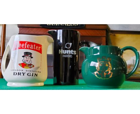 A Beefeater London Dry Gin advertising whisky water jug by Wade; HUNT'S Mixer jug by Wade and a 'Prince of Wales' water jug. 