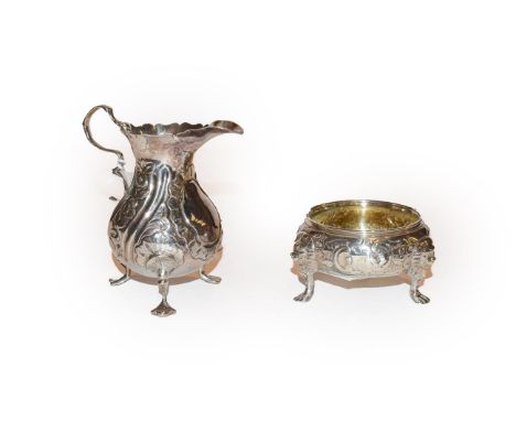 A George II Irish silver salt-cellar and a George III silver cream jug, the first with rubbed marked, Circa 1750, the second 