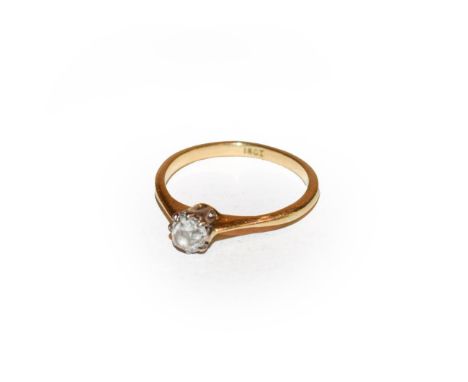 A diamond solitaire ring, the old cut diamond in a white claw setting, to a yellow tapered shoulder plain polished shank, fin