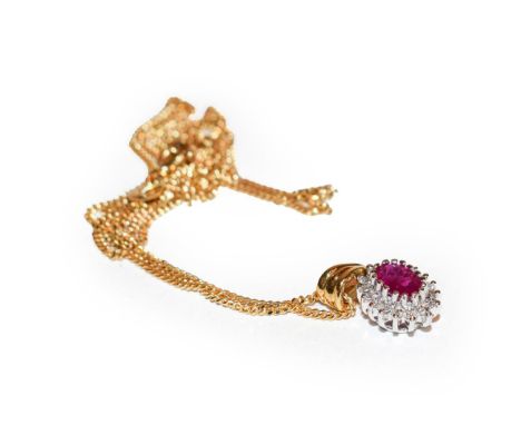 An 18 carat gold ruby and diamond cluster pendant on chain, the oval cut ruby within a border of round brilliant cut diamonds