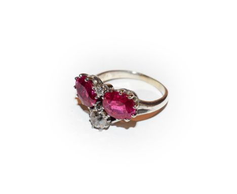 A synthetic ruby and diamond ring, realistically modelled as a wishbone, formed of two oval cut synthetic rubies and two old 