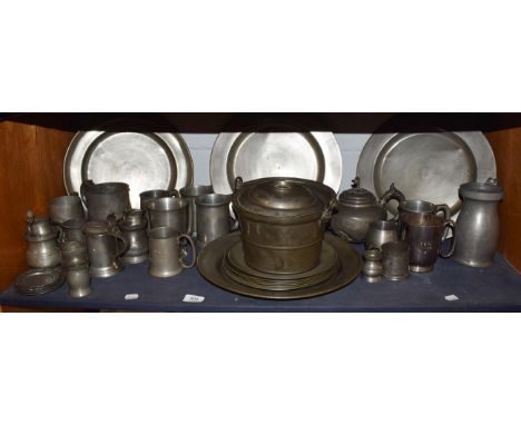 A large collection of 18th century and later Pewter, including a lidded pot with swing handle, large serving dishes and plate