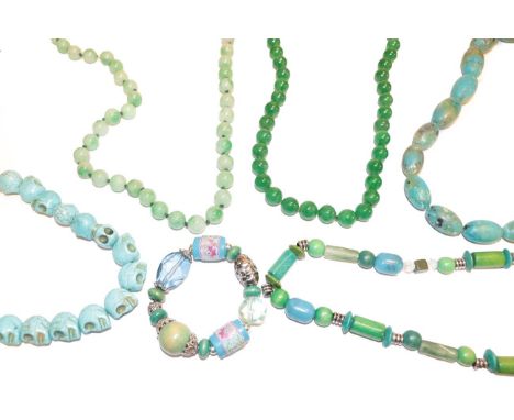 A jade bead necklace, length 102cm, a jade type necklace, length 84cm and various other blue glass bead necklaces and a brace