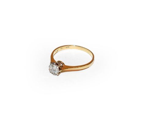 A diamond solitaire ring, the round brilliant cut diamond in a white claw setting, to a tapered shoulder plain polished shank