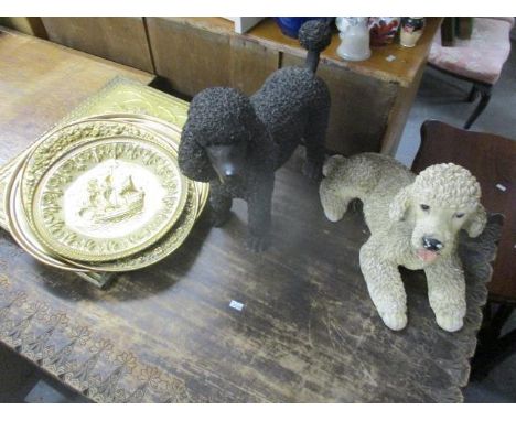 Two model poodles and brassware to include embossed plates 