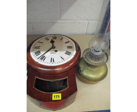 A mahogany wall clock A/F and a brass oil lamp 