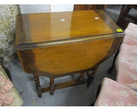 An early 20th century oak gate leg table having barley twist supports, 29" h x 24"w 