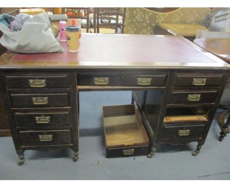 An early 20th century mahogany, twin pedestal desk with red leather topped scriber 