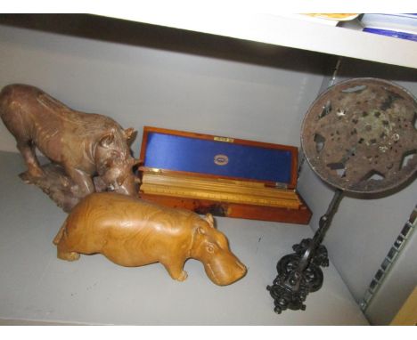 A late 19th/early 20th century wooden cased set of wooden rulers, an African carved stone model of a wart-hog, a wooden carve