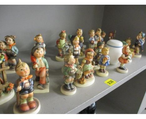 A collection of Hummel figures, together with a Carlton ware commemorative jar 