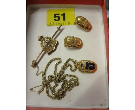 A 9ct gold and enamelled Royal Army Medical Sweetheart brooch, a yellow metal and enamelled Egyptian scarab beetle on a gold 