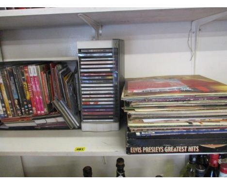 A large quantity of CDs and records to include Elvis 