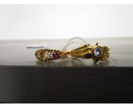 A yellow metal and white stone set solitaire ring and an 18ct yellow gold diamond and ruby ring, one stone deficient 