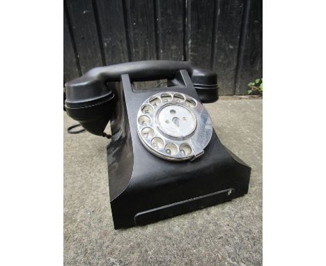 A vintage black cased dial telephone, model number 164, converted for use 