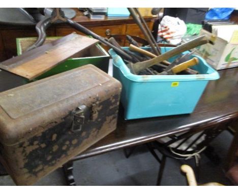 A mixed lot of tools to include axes, a brush, files and other items, together with a black metal box 