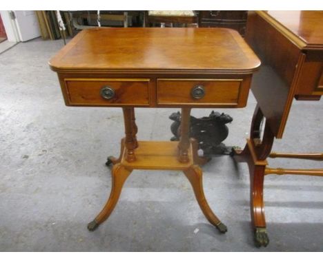 A modern yew pedestal, twin drawer lamp table, raised on splayed legs 