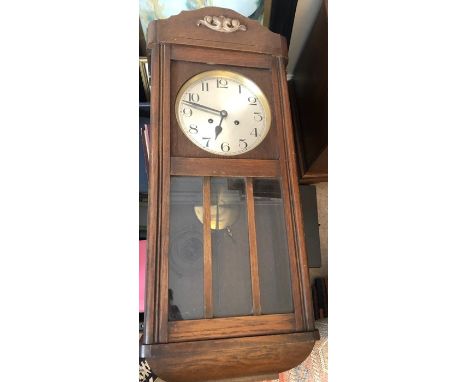 An oak cased wall clock. 