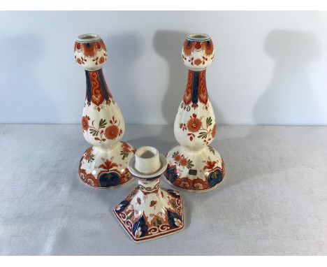 Pair of Delft tall candlesticks, 23.5cms h and a a smaller candlestick, 11.5cms h. 