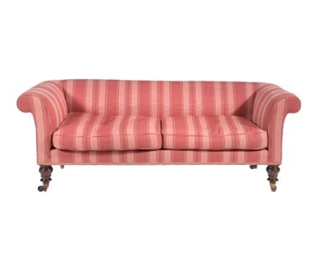 An early Victorian mahogany sofa, circa 1840, with integral back and arms, above two removable cushions and turned legs, 72cm