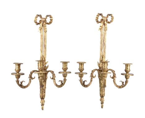 A set of four gilt metal three light wall appliques in Louis XVI style, 20th century, the dentil cast and beaded sconces on s