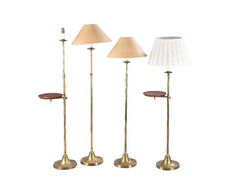 A pair of brass and stained hardwood standard lamps, second half 20th century, each with an adjustable circular tray and on s