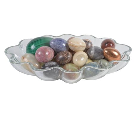 A collection of approximately 25 polished hardstone models of eggs, including a substantial example in malachite, an incised 