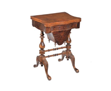 A Victorian walnut games and work table, circa 1870, the hinged top opening to specimen timber inlaid backgammon, chess, and 