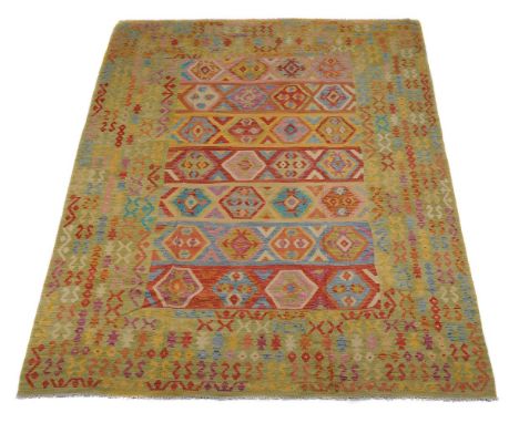 A Kilim carpet, woven in polychrome, with geometric motifs throughout, approximately 343 x 244cm