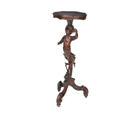 A carved beech torchere, late 19th century, possibly Venetian,  the shaped platform above a young turbaned male holding a bun