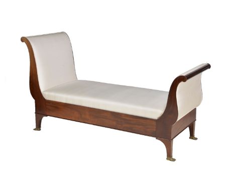 A mahogany and upholstered day bed in Empire style, 20th century, of bateau shape with outscrolled head and foot, the  bracke